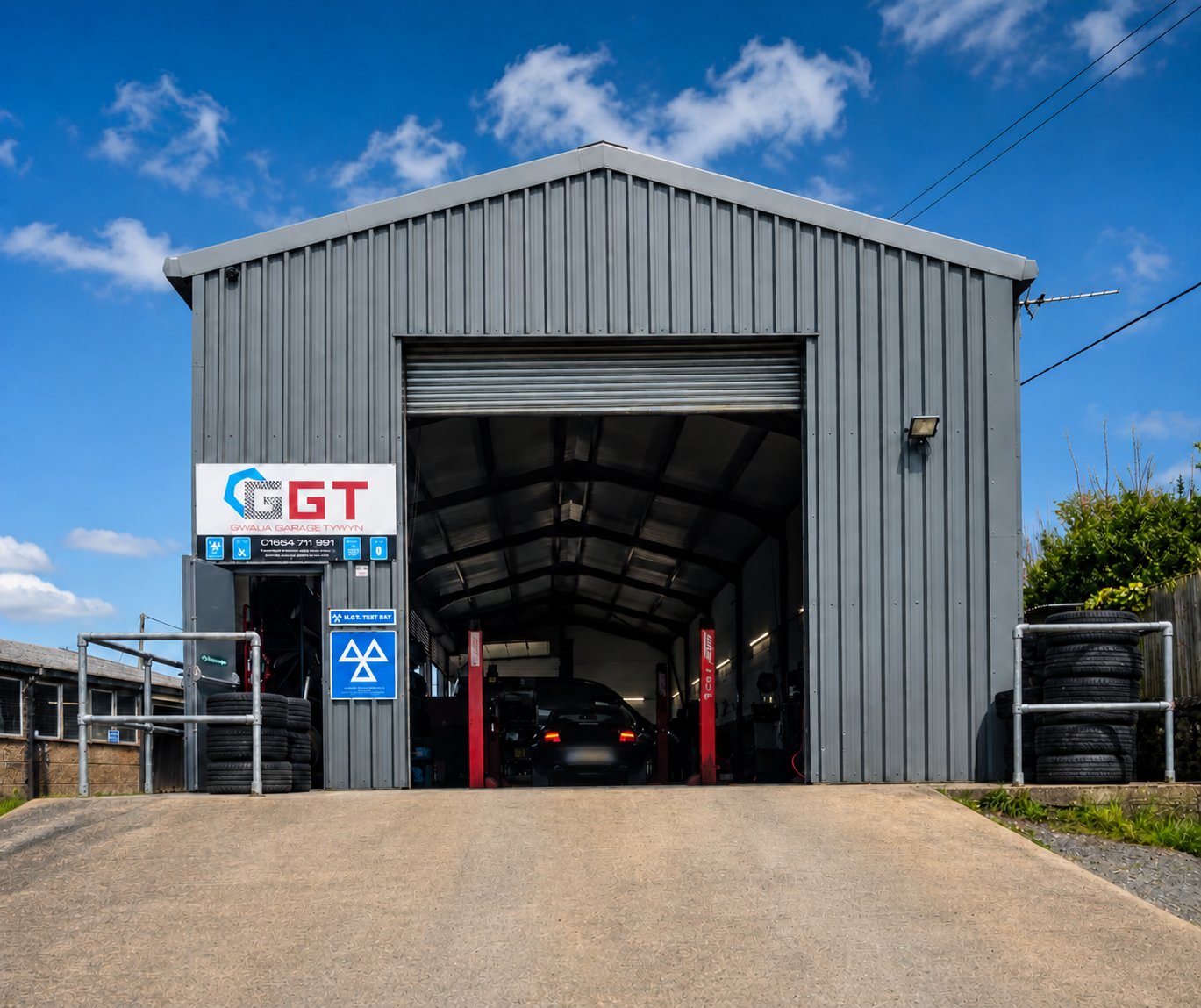 Vehicle on 4-wheel alignment equipment at Modurol Dyfi garage workshop, Tywyn Gwynedd
